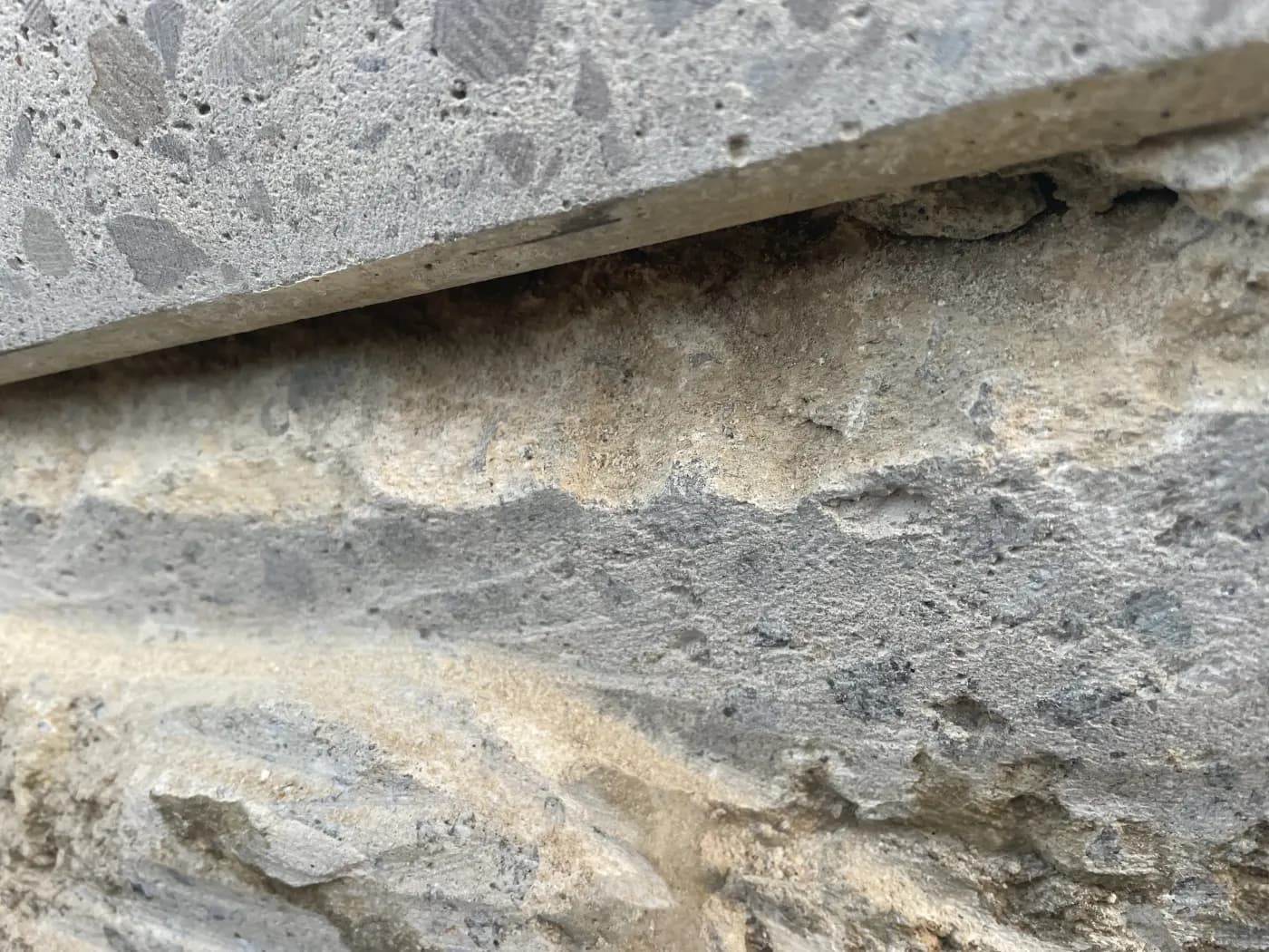 A panel joint with the concrete degraded back to exposed aggregate