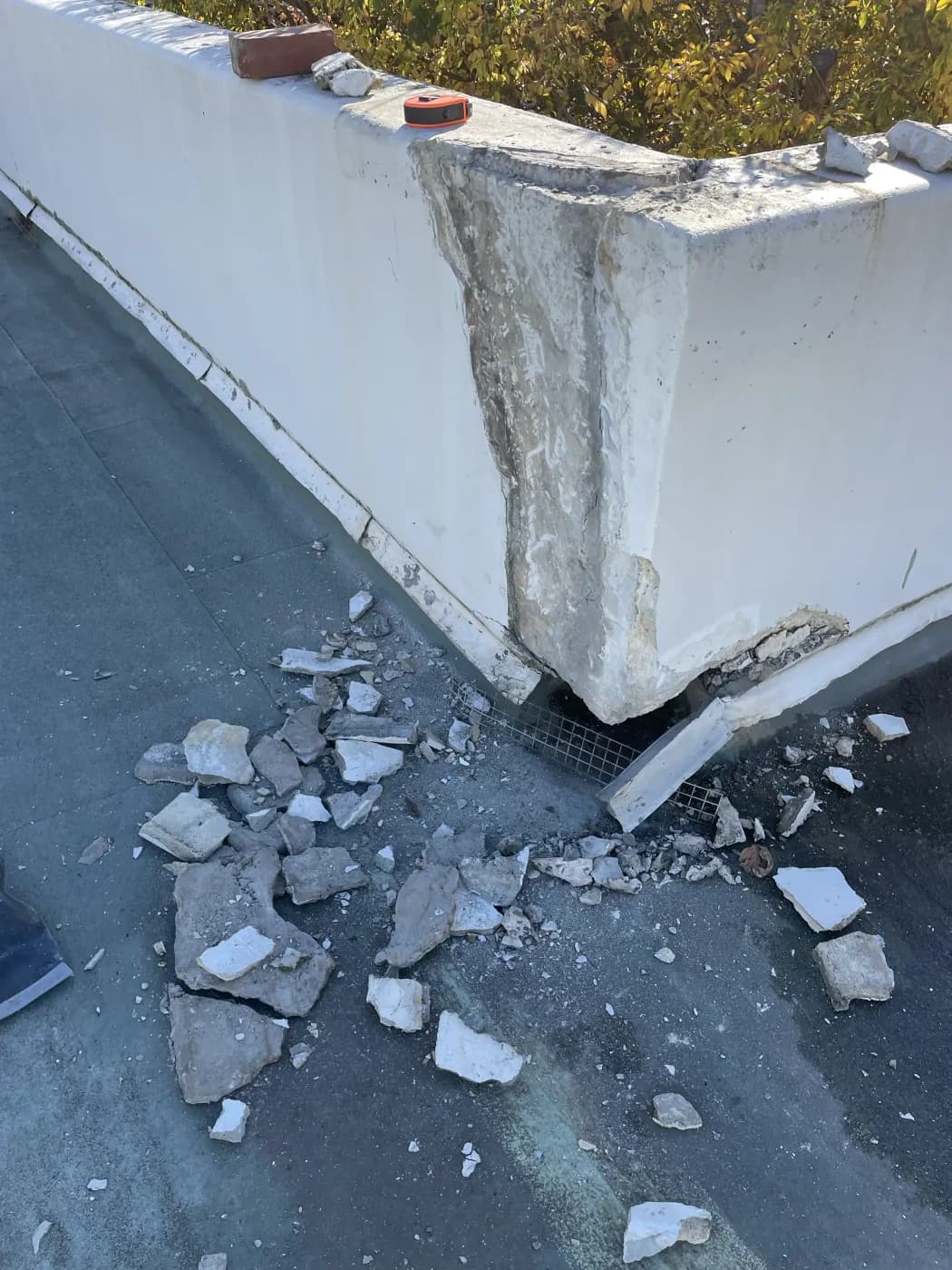 Rubble and failed material across the deck at the parapet junction