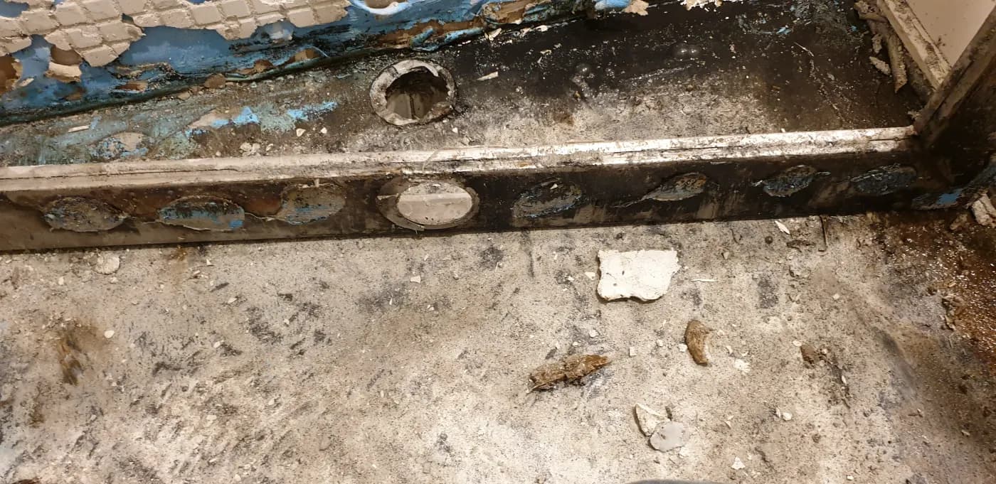 The shower hob and outlet opened up, showing where the pod was installed without a water stop