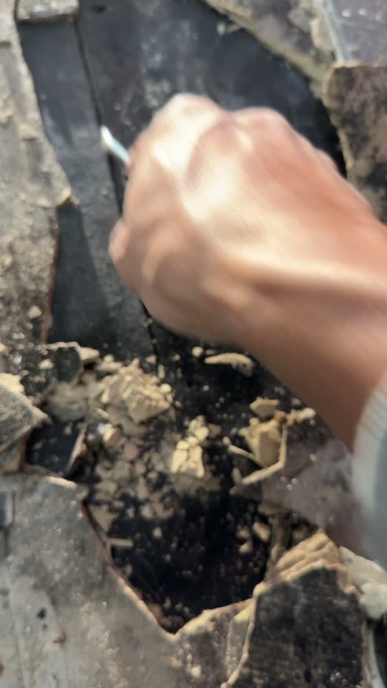 Failed screed broken back to expose a delaminated membrane beneath